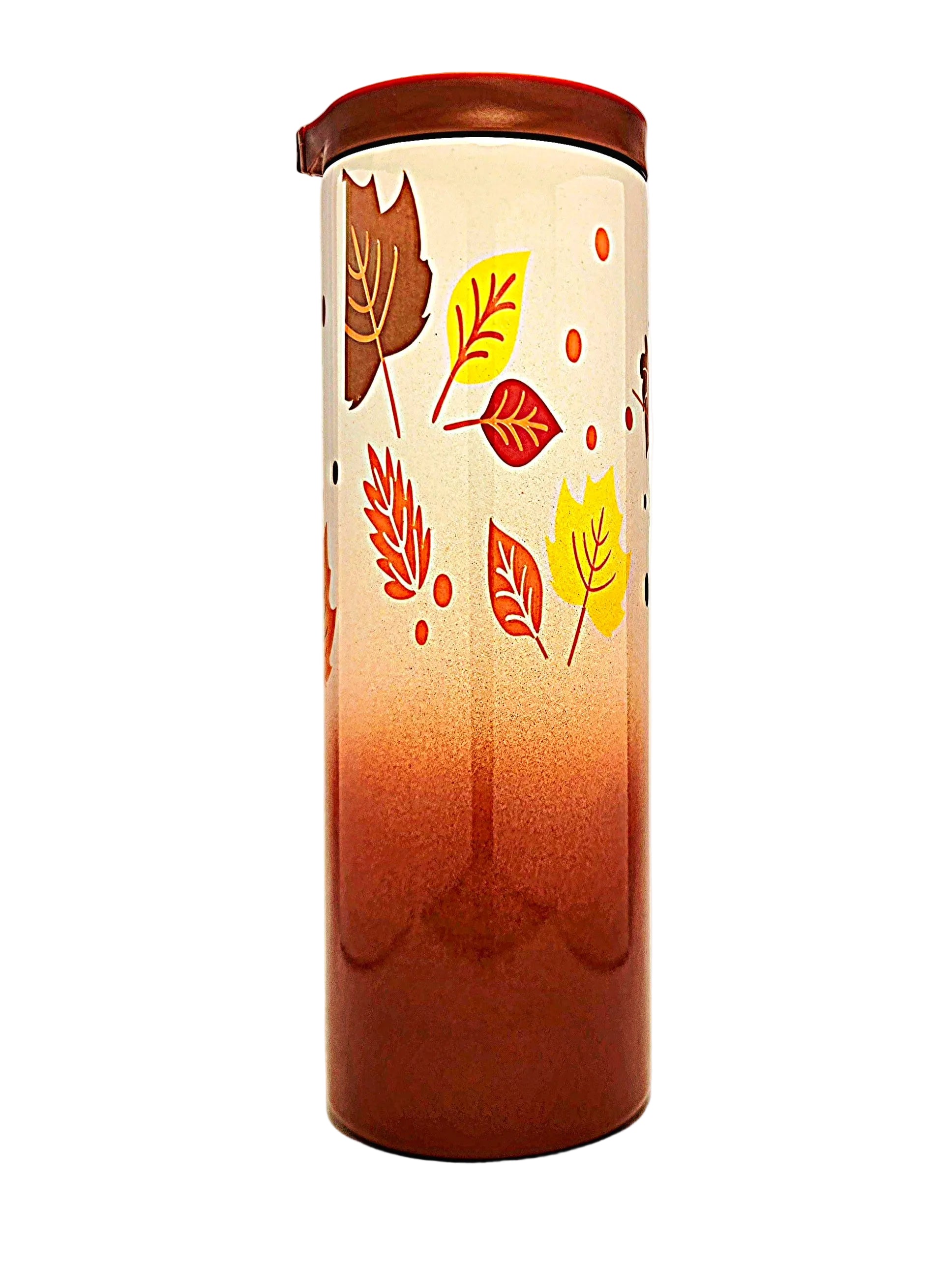 A tall cylindrical tumbler with a lid, featuring a warm gradient from deep reddish-brown at the bottom to off-white at the top, decorated with colorful autumn leaves in yellow, red, and brown.