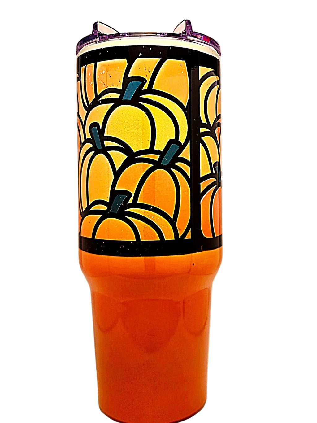 An orange tumbler with a black and orange pumpkin pattern on the upper half and a clear lid.