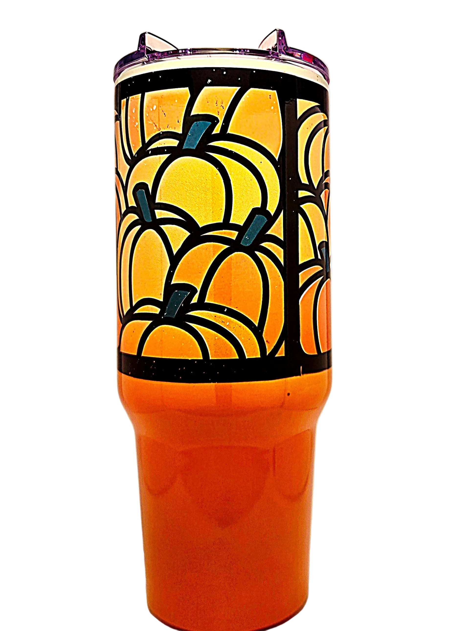 An orange tumbler with a black and orange pumpkin pattern on the upper half and a clear lid.